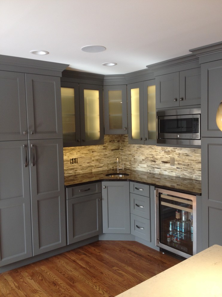 Inspiration for a mid-sized timeless l-shaped medium tone wood floor eat-in kitchen remodel in Cincinnati with recessed-panel cabinets, gray cabinets, granite countertops, stainless steel appliances, an island and a single-bowl sink