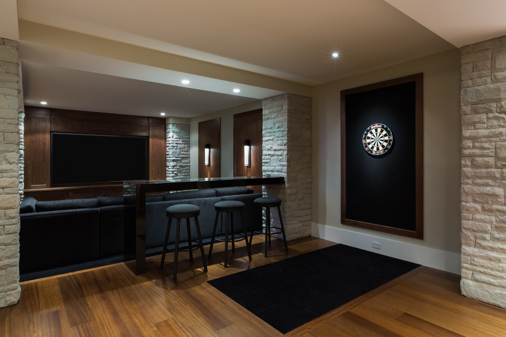 Photo of a large contemporary enclosed home theatre in Vancouver with beige walls, medium hardwood floors and a built-in media wall.