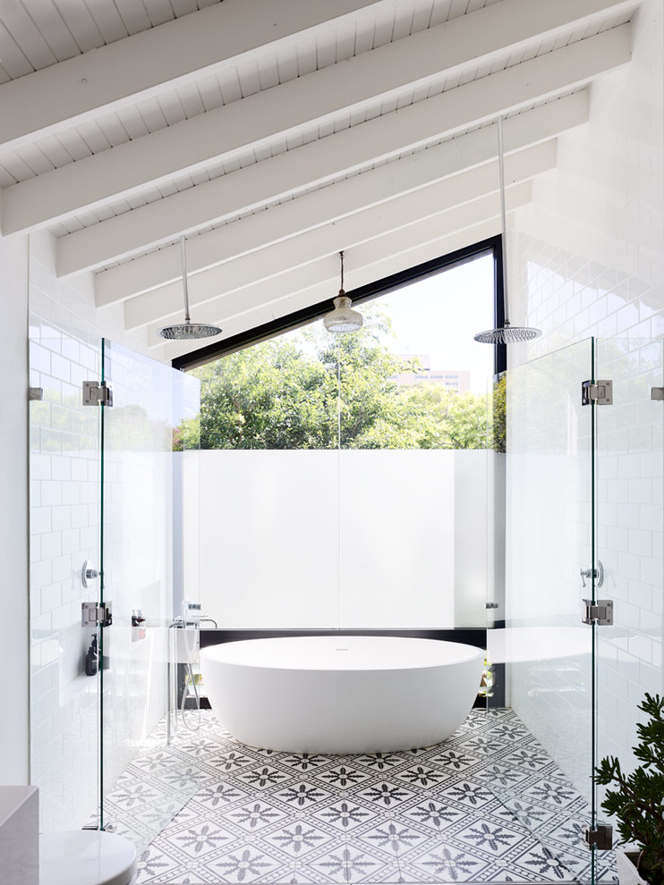Contemporary master bathroom in Sydney with a freestanding tub, a double shower, white tile and white walls.