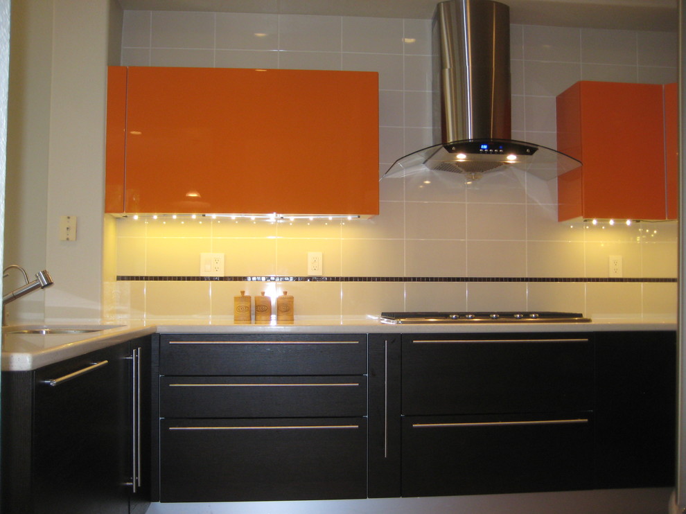 Inspiration for a small contemporary u-shaped eat-in kitchen in San Diego with an undermount sink, flat-panel cabinets, orange cabinets, solid surface benchtops, beige splashback, ceramic splashback, stainless steel appliances and porcelain floors.