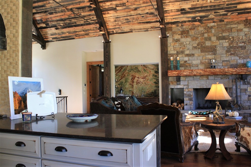 Inspiration for a huge rustic l-shaped open concept kitchen remodel with an undermount sink, quartz countertops, beige backsplash, stone tile backsplash, stainless steel appliances and an island