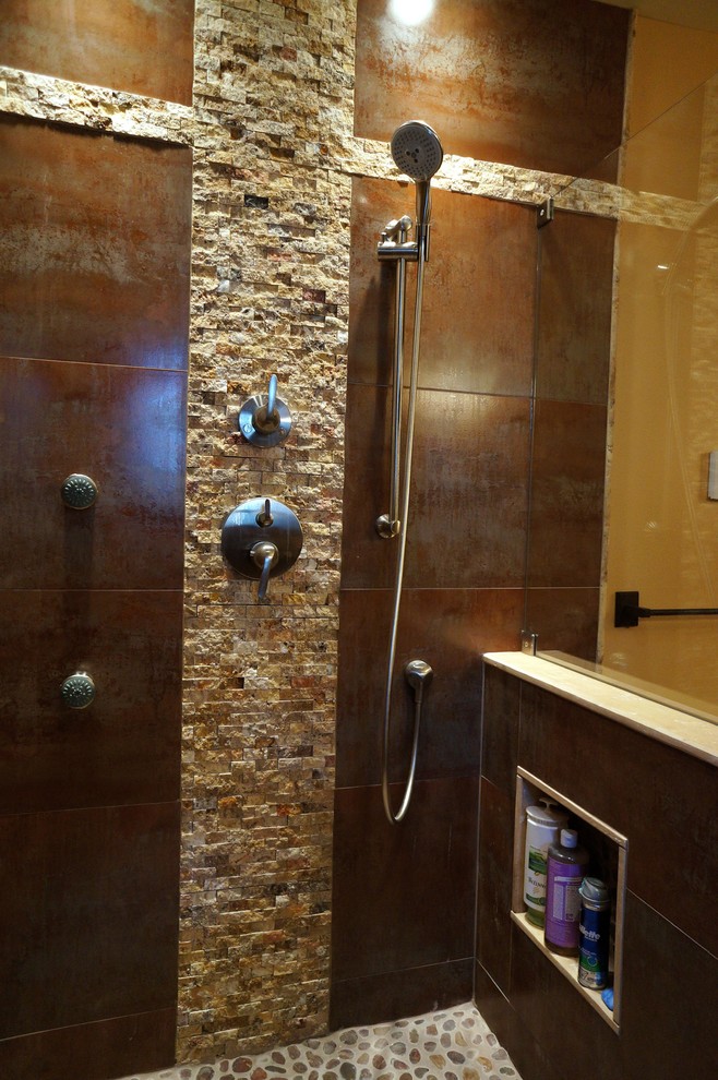 This is an example of a mid-sized asian master bathroom in Philadelphia with raised-panel cabinets, black cabinets, an alcove shower, a wall-mount toilet, brown walls, slate floors, a vessel sink and limestone benchtops.