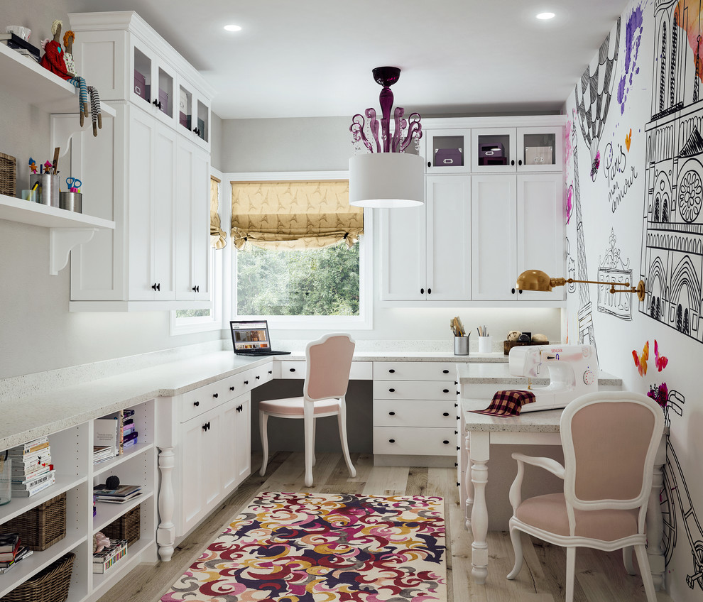 Photo of a transitional craft room in Sacramento with multi-coloured walls, light hardwood floors, no fireplace and a built-in desk.