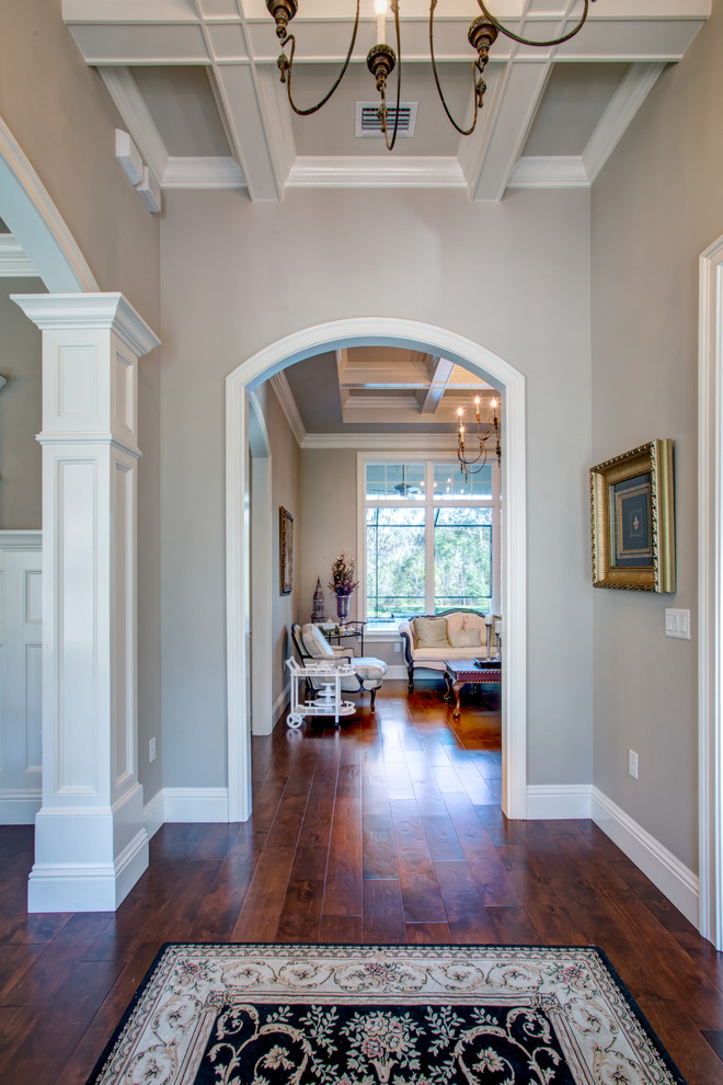 Foyer - large transitional dark wood floor and brown floor foyer idea in Orlando with beige walls and a glass front door