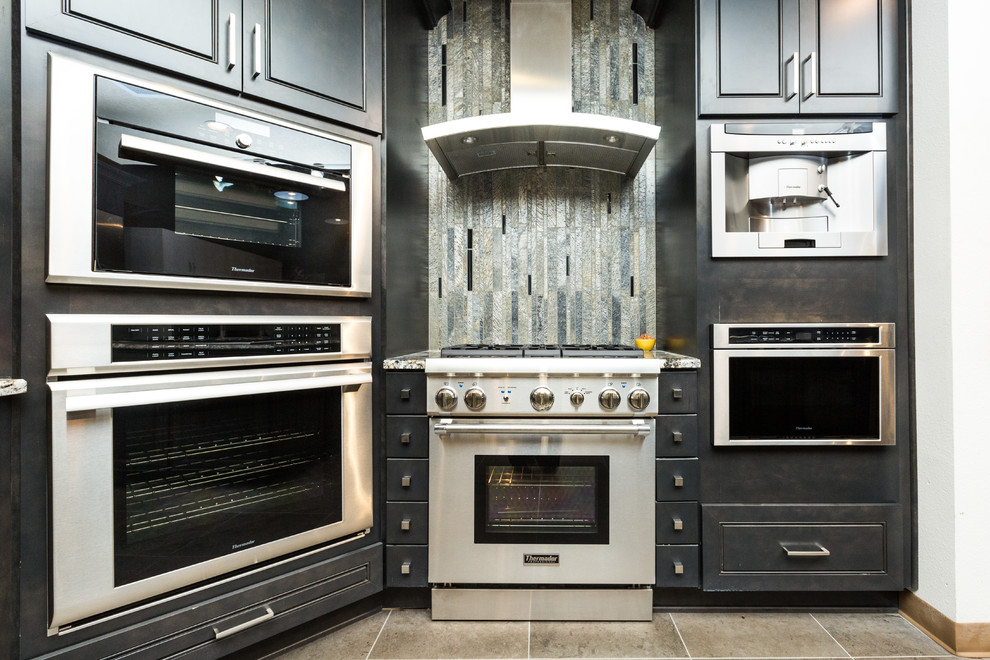 Mid-sized transitional porcelain tile kitchen photo in Albuquerque with granite countertops, glass tile backsplash, stainless steel appliances and an island