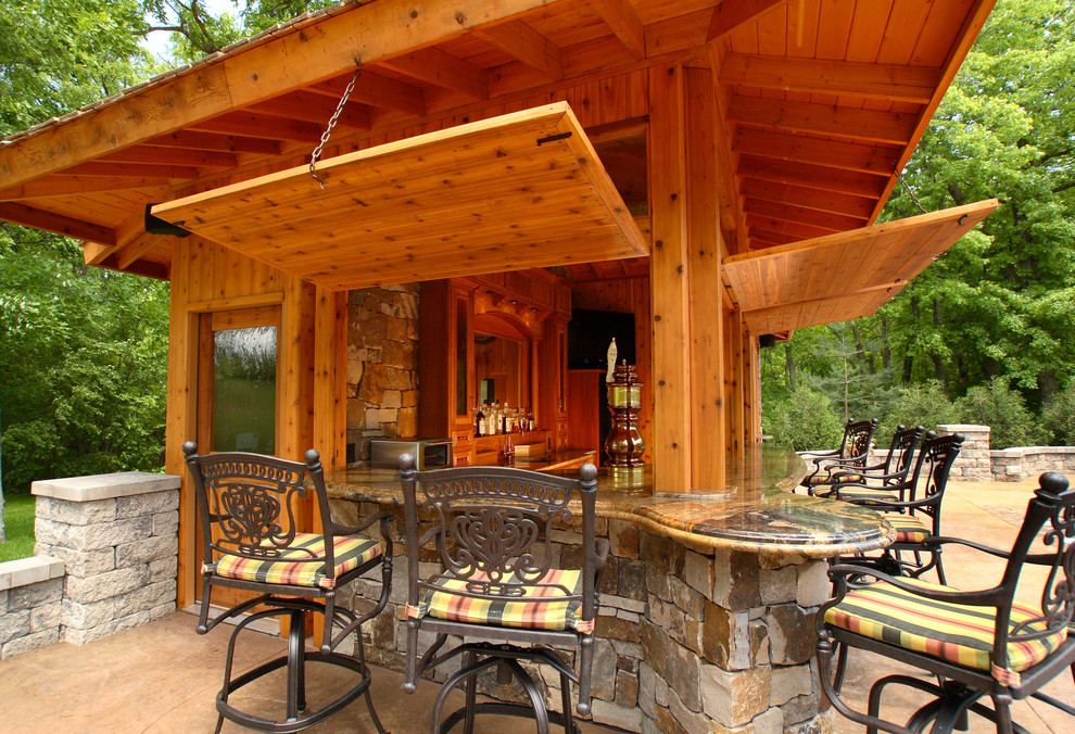 Mid-sized mountain style backyard stamped concrete patio kitchen photo in Minneapolis with a gazebo