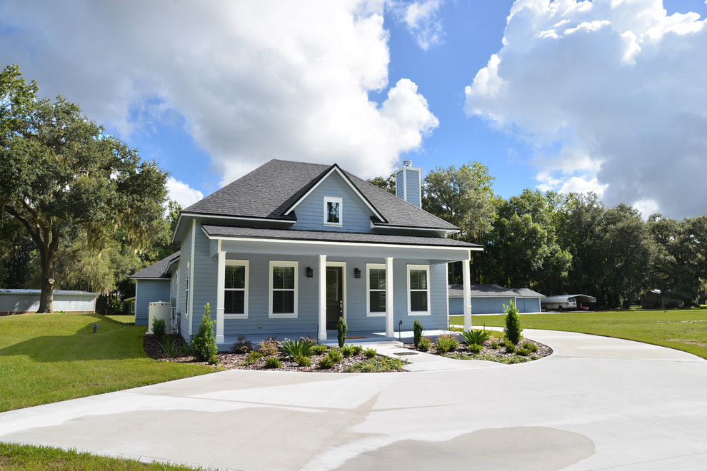 Photo of a large country one-storey blue exterior in Jacksonville with vinyl siding and a gambrel roof.