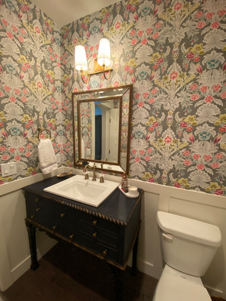 This is an example of a traditional bathroom in Boise with blue cabinets, dark hardwood floors, a drop-in sink, a single vanity, a freestanding vanity and wallpaper.