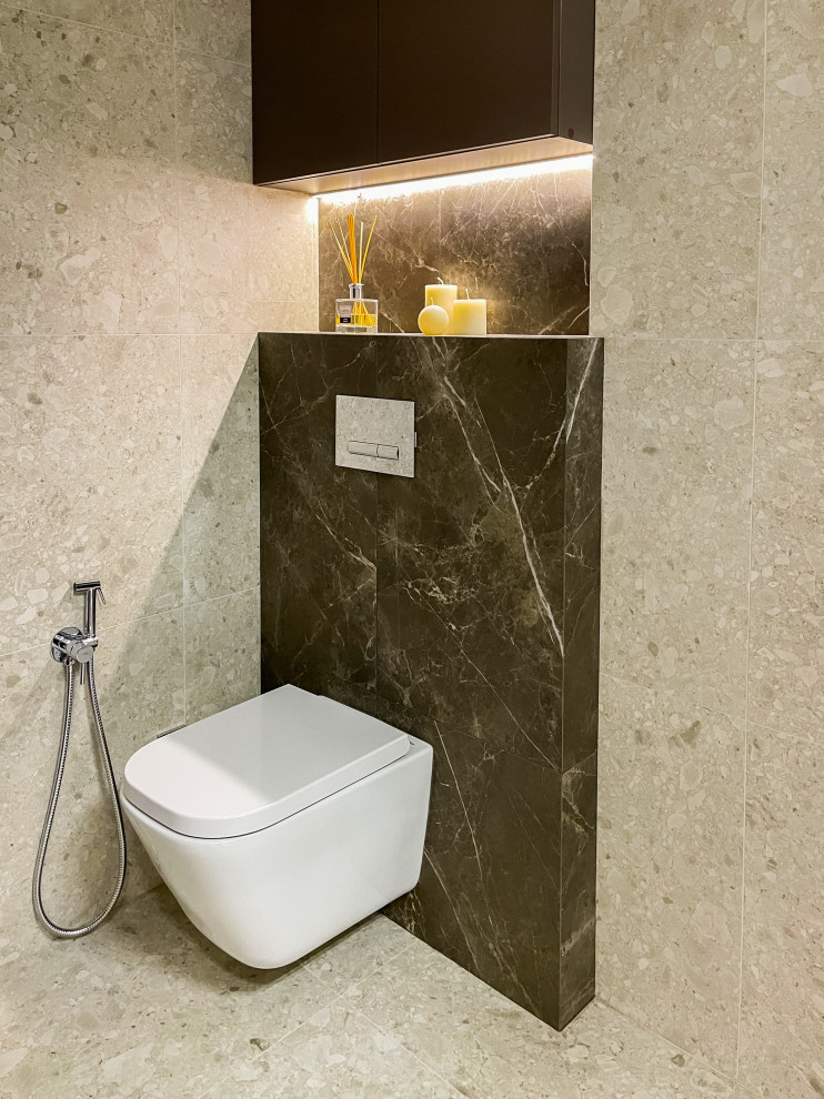 Inspiration for a small contemporary cloakroom in Moscow with open cabinets, white cabinets, a wall mounted toilet, brown tiles, ceramic tiles, beige walls, ceramic flooring, a wall-mounted sink, beige floors, feature lighting and a floating vanity unit.