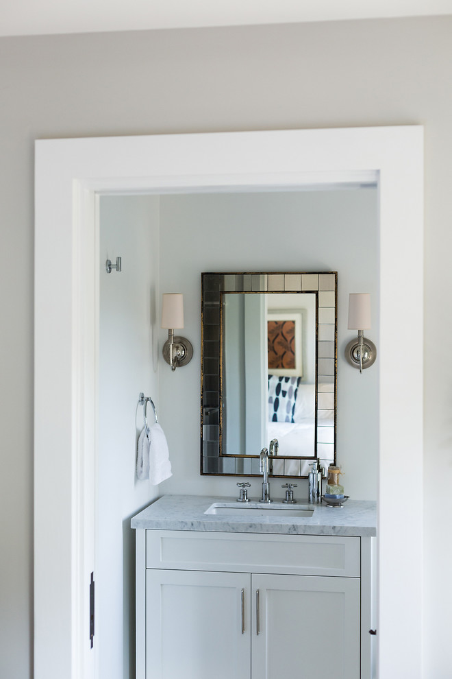 Design ideas for a transitional powder room in Santa Barbara with an undermount sink, shaker cabinets, white cabinets and white walls.