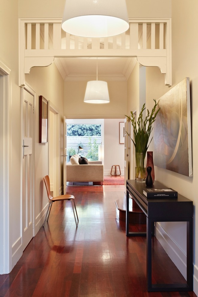 Mid-sized contemporary entry hall in Melbourne with white walls and dark hardwood floors.