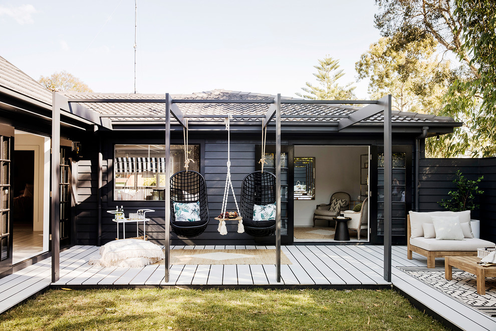 Photo of a contemporary backyard deck in Sydney with a pergola.