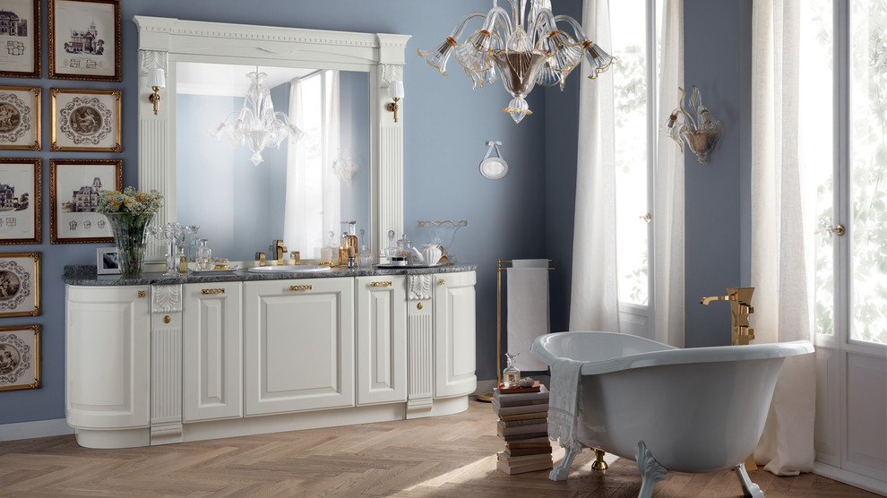 This is an example of a large traditional master bathroom in Melbourne with an undermount sink, raised-panel cabinets, white cabinets, quartzite benchtops, a claw-foot tub, blue walls and medium hardwood floors.