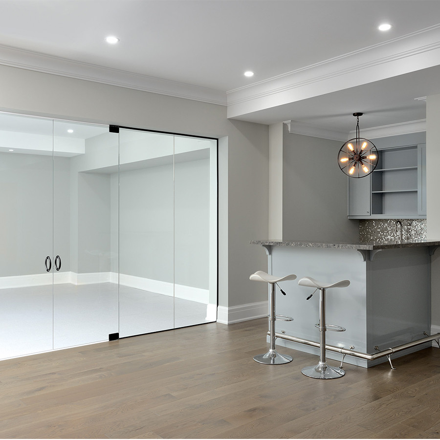 Inspiration for a large transitional underground medium tone wood floor and brown floor basement remodel with gray walls and a bar