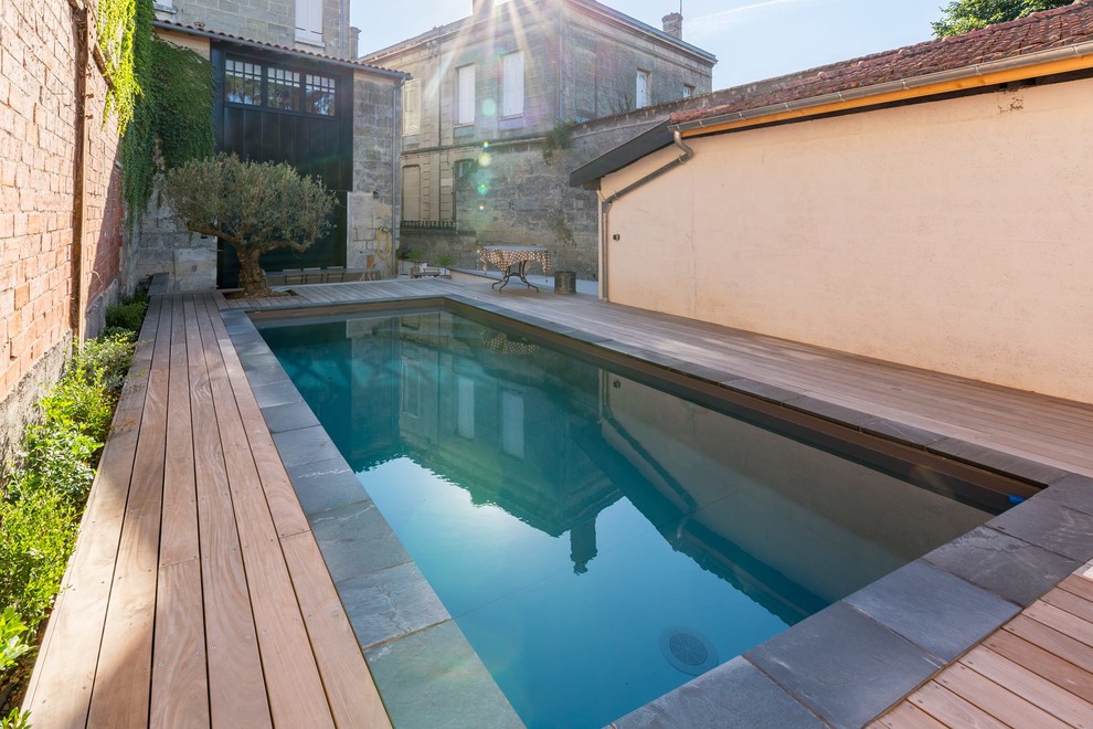 Small mediterranean backyard rectangular pool in Bordeaux with decking.