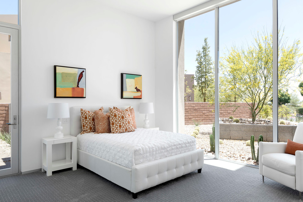 Expansive contemporary guest bedroom in Las Vegas with white walls, carpet and no fireplace.