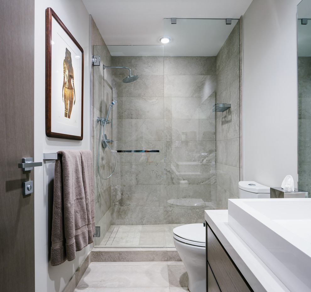Design ideas for a mid-sized contemporary 3/4 bathroom in Vancouver with flat-panel cabinets, dark wood cabinets, a double shower, a two-piece toilet, beige tile, porcelain tile, beige walls, medium hardwood floors, a vessel sink, quartzite benchtops, grey floor and a hinged shower door.