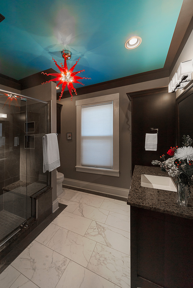 Inspiration for a mid-sized transitional master bathroom in Columbus with an undermount sink, shaker cabinets, dark wood cabinets, engineered quartz benchtops, an alcove shower, a two-piece toilet, gray tile, porcelain tile, grey walls and porcelain floors.