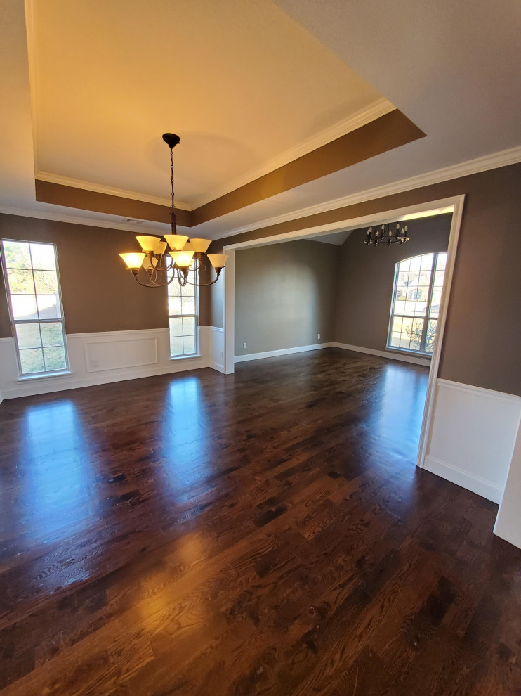 Photo of a medium sized contemporary open plan living room in Other with brown walls, dark hardwood flooring, brown floors, a drop ceiling and wainscoting.