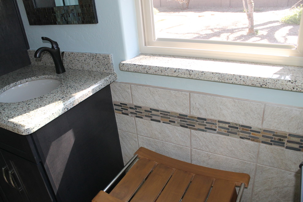 Walk-in shower - mid-sized transitional master beige tile and porcelain tile porcelain tile and brown floor walk-in shower idea in Phoenix with flat-panel cabinets, black cabinets, a two-piece toilet, blue walls, an undermount sink and quartz countertops