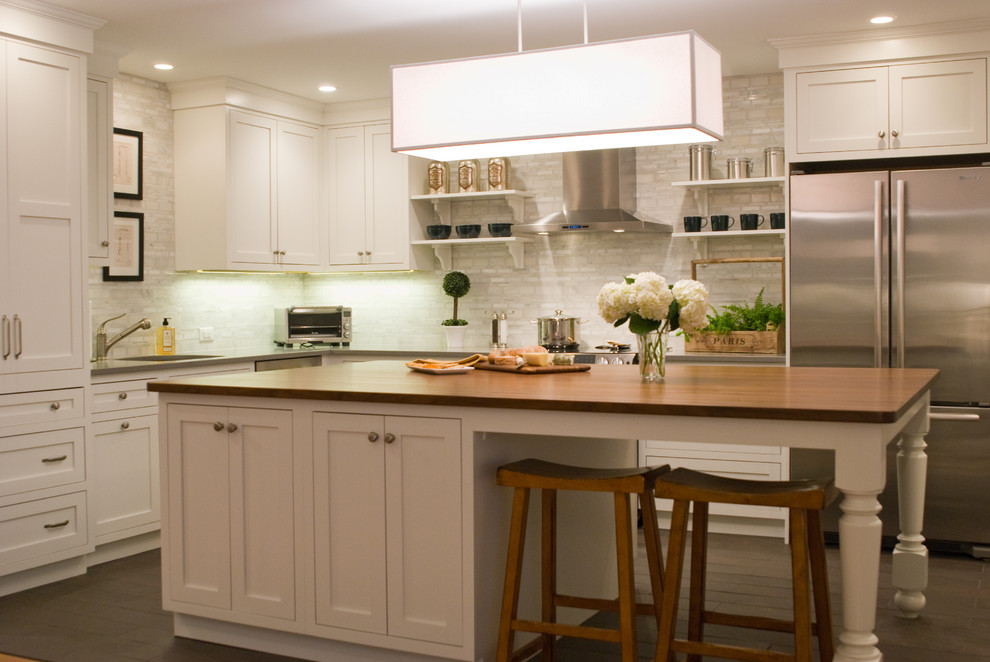 Design ideas for a traditional kitchen in Boston with recessed-panel cabinets, white cabinets, wood benchtops and stainless steel appliances.