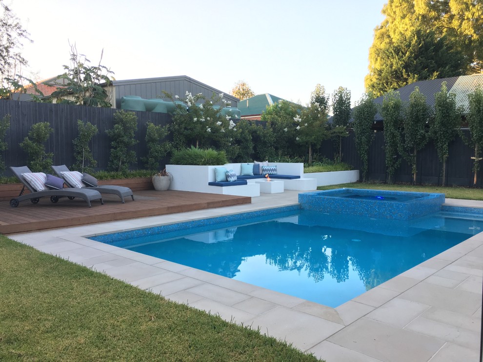 Inspiration for a large modern backyard rectangular pool in Melbourne with concrete pavers.