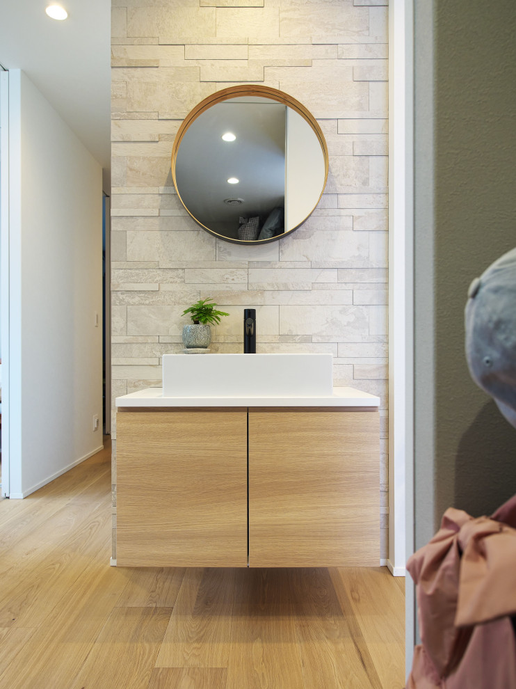 Design ideas for a scandinavian cloakroom in Osaka with open cabinets, white cabinets, grey tiles, porcelain tiles, white walls, medium hardwood flooring, a vessel sink, white worktops, a feature wall, a built in vanity unit and a wallpapered ceiling.