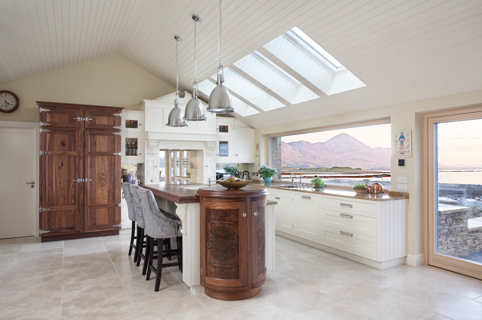 Inspiration for a mid-sized traditional l-shaped kitchen in Other with beaded inset cabinets, white cabinets, granite benchtops, mirror splashback, panelled appliances, with island and grey floor.