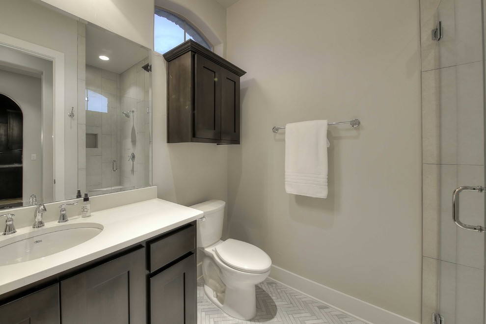Design ideas for a large transitional master bathroom in Austin with dark wood cabinets, a corner shower, gray tile, beige walls, a drop-in sink and granite benchtops.