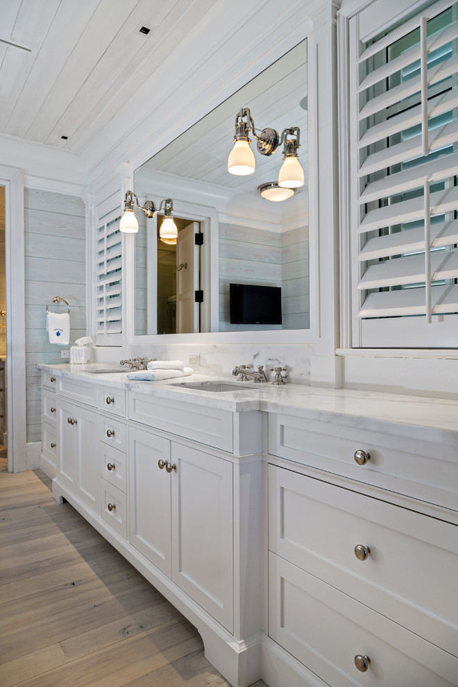 Inspiration for a large traditional master bathroom in Miami with an undermount sink, recessed-panel cabinets, white cabinets, grey walls and light hardwood floors.