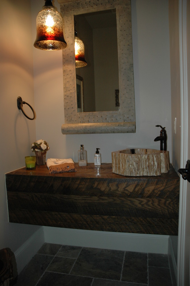 Example of a small transitional 3/4 brown tile and stone tile porcelain tile bathroom design with a drop-in sink, open cabinets, dark wood cabinets, wood countertops, a two-piece toilet and beige walls