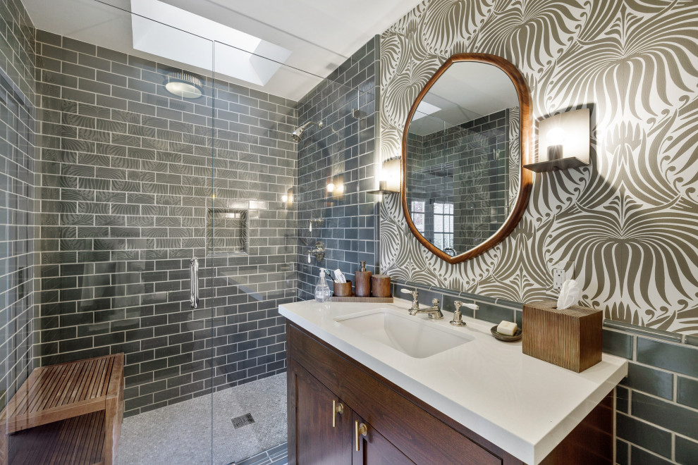 Photo of a small traditional bathroom in San Francisco with shaker cabinets, dark wood cabinets, a one-piece toilet, green tile, porcelain tile, multi-coloured walls, ceramic floors, an undermount sink, quartzite benchtops, beige floor, a hinged shower door, white benchtops, a single vanity, a freestanding vanity and wallpaper.