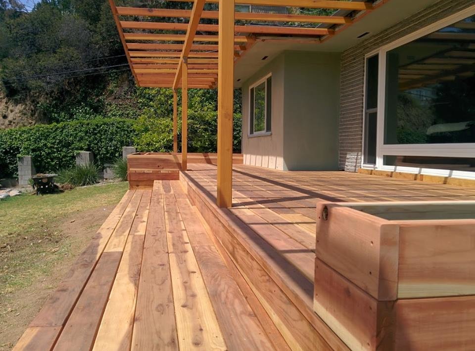 Small arts and crafts backyard deck in Los Angeles with a container garden and a pergola.