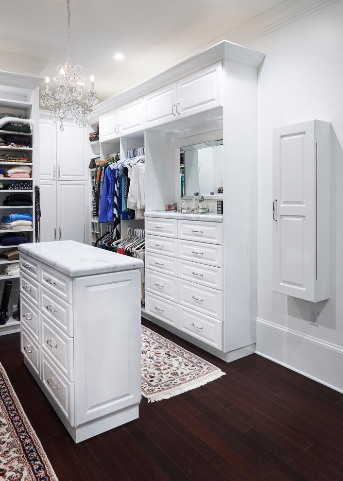 This is an example of a large contemporary gender-neutral walk-in wardrobe in Philadelphia with recessed-panel cabinets, white cabinets and dark hardwood floors.