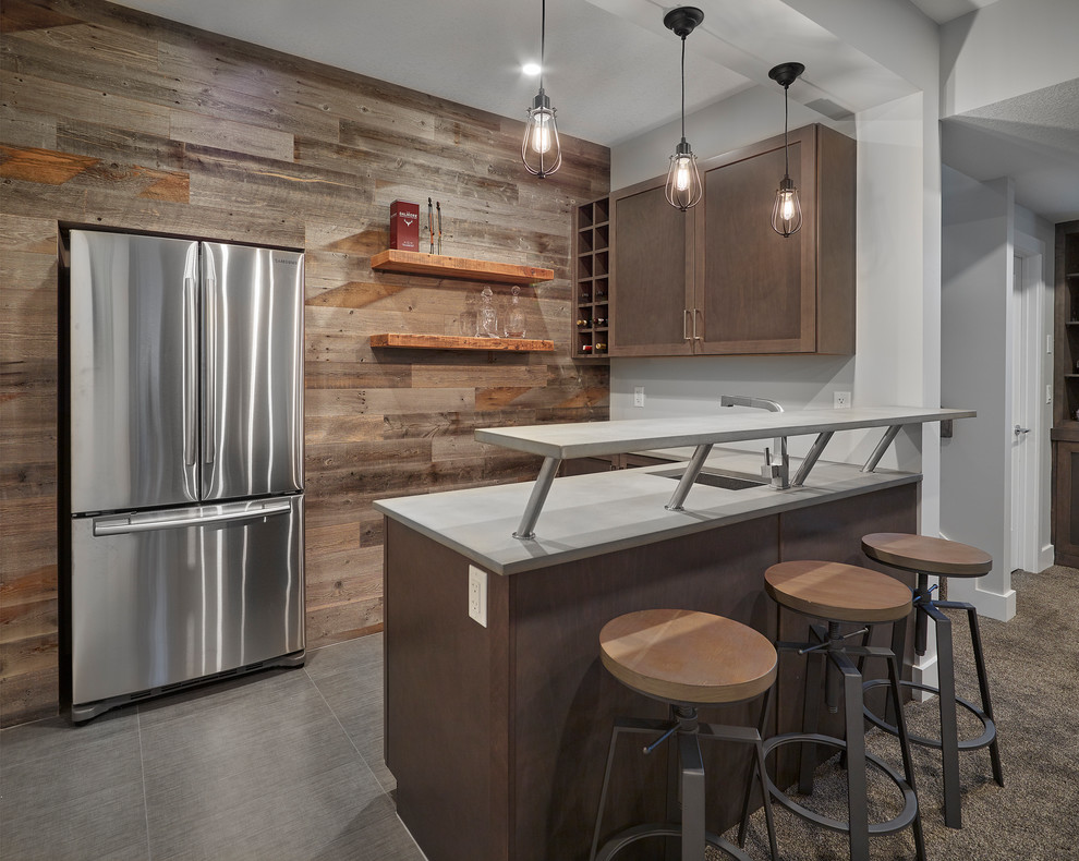 Mid-sized transitional l-shaped seated home bar in Edmonton with an undermount sink, quartz benchtops, ceramic floors, grey benchtop, shaker cabinets, dark wood cabinets and grey floor.