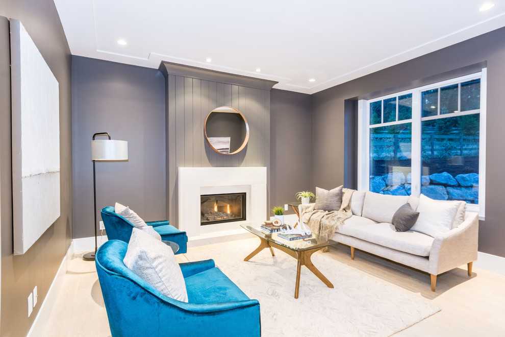 Inspiration for a mid-sized beach style formal living room in Brisbane with grey walls, light hardwood floors, a standard fireplace, a plaster fireplace surround and beige floor.