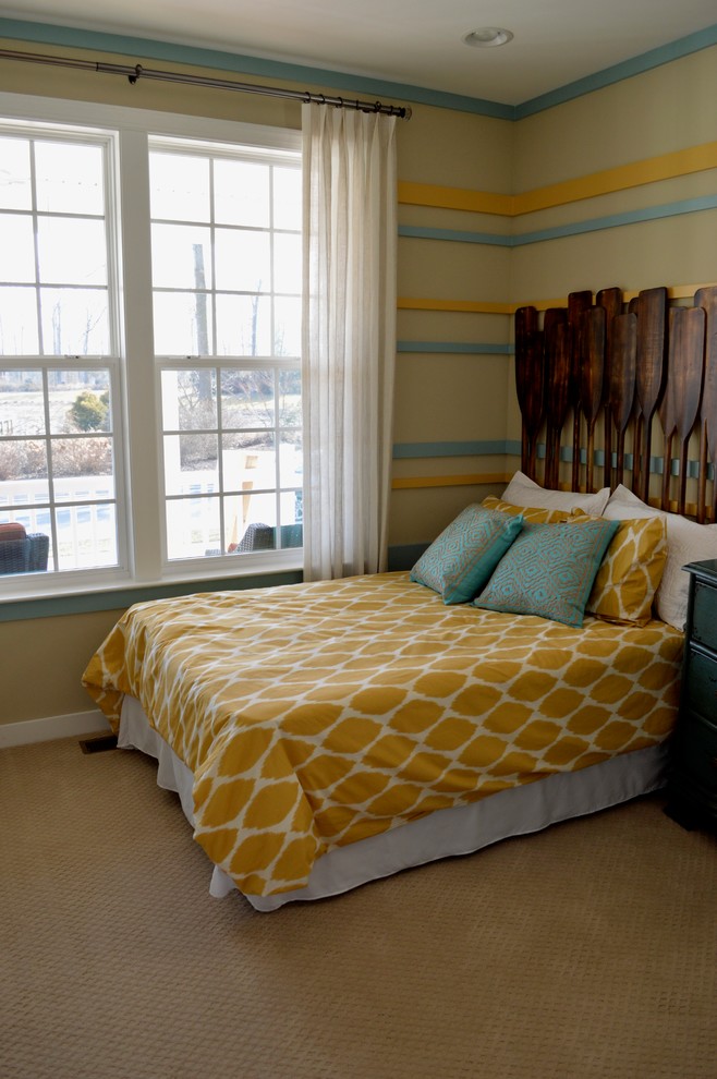 Inspiration for a beach style guest bedroom in DC Metro with yellow walls and carpet.