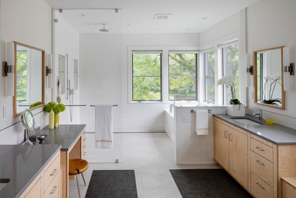 This is an example of a contemporary bathroom in Boston with flat-panel cabinets, light wood cabinets, an open shower, white walls, an undermount sink, white floor, an open shower and grey benchtops.