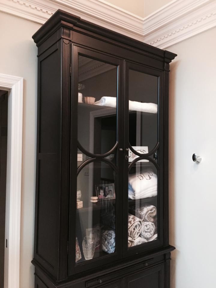 Example of a mid-sized transitional master travertine floor and beige floor doorless shower design with shaker cabinets, brown cabinets, beige walls, an undermount sink and quartz countertops
