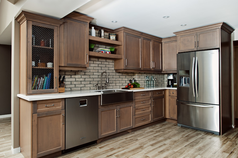 Example of a large mountain style u-shaped light wood floor eat-in kitchen design in Toronto with a farmhouse sink, recessed-panel cabinets, medium tone wood cabinets, quartz countertops, beige backsplash, stainless steel appliances and an island