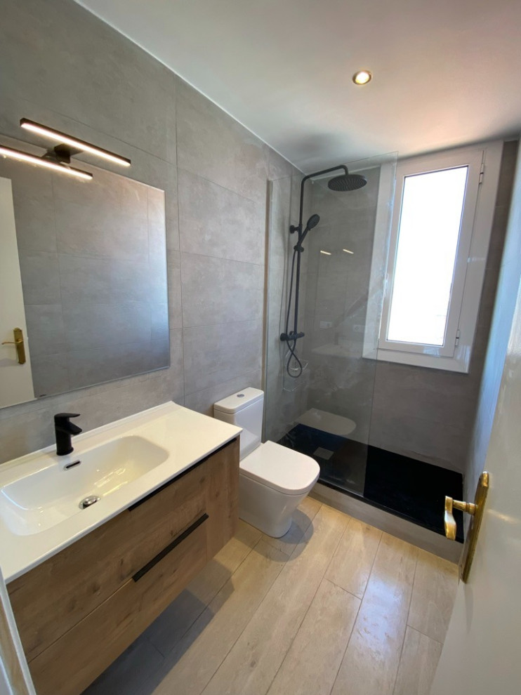 Design ideas for a small modern 3/4 bathroom in Barcelona with recessed-panel cabinets, beige cabinets, an open shower, a wall-mount toilet, beige tile, grey walls, wood-look tile, an integrated sink, solid surface benchtops, beige floor, an open shower, white benchtops, an enclosed toilet, a single vanity and a freestanding vanity.