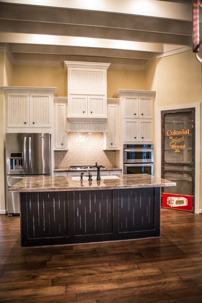 Inspiration for a mid-sized rustic medium tone wood floor kitchen remodel in Houston with a farmhouse sink, white cabinets, granite countertops, beige backsplash, ceramic backsplash, stainless steel appliances and an island