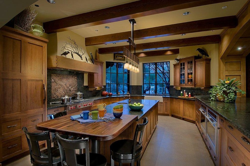 Eat-in kitchen - mid-sized rustic l-shaped eat-in kitchen idea in Phoenix with a farmhouse sink, medium tone wood cabinets, granite countertops, stone slab backsplash, stainless steel appliances and an island