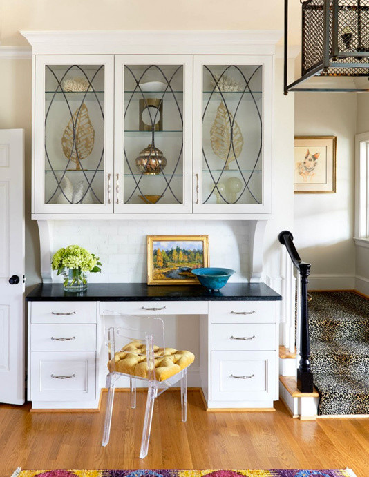 Enclosed kitchen - large transitional light wood floor enclosed kitchen idea in Charlotte with a farmhouse sink, recessed-panel cabinets, white cabinets, onyx countertops, white backsplash, subway tile backsplash, stainless steel appliances and an island