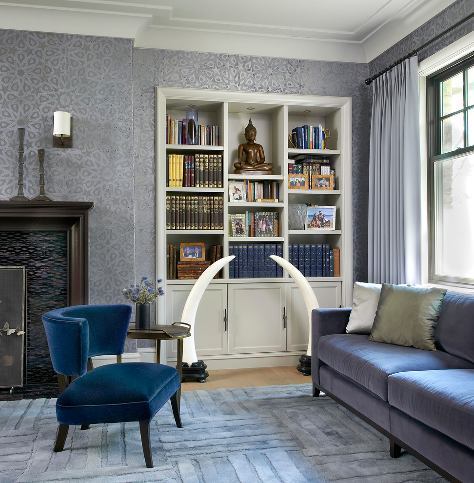 Photo of a mid-sized transitional formal enclosed living room in Chicago with blue walls, light hardwood floors, a standard fireplace and a tile fireplace surround.