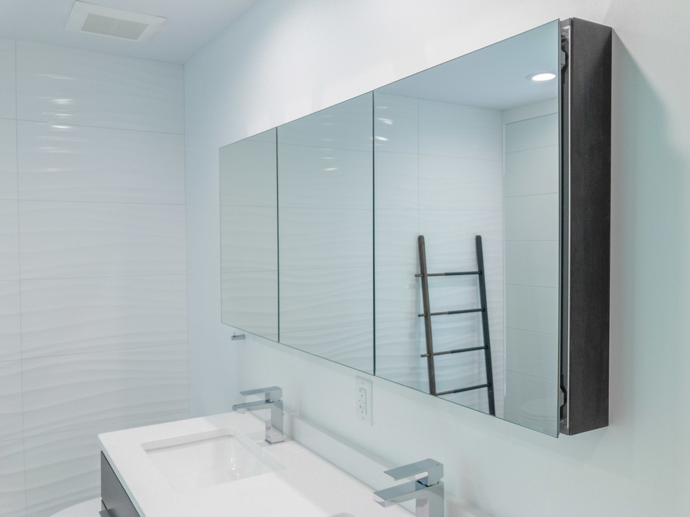 Photo of a mid-sized modern master bathroom in Raleigh with flat-panel cabinets, brown cabinets, an open shower, a one-piece toilet, white tile, ceramic tile, white walls, porcelain floors, an undermount sink, engineered quartz benchtops, grey floor and an open shower.