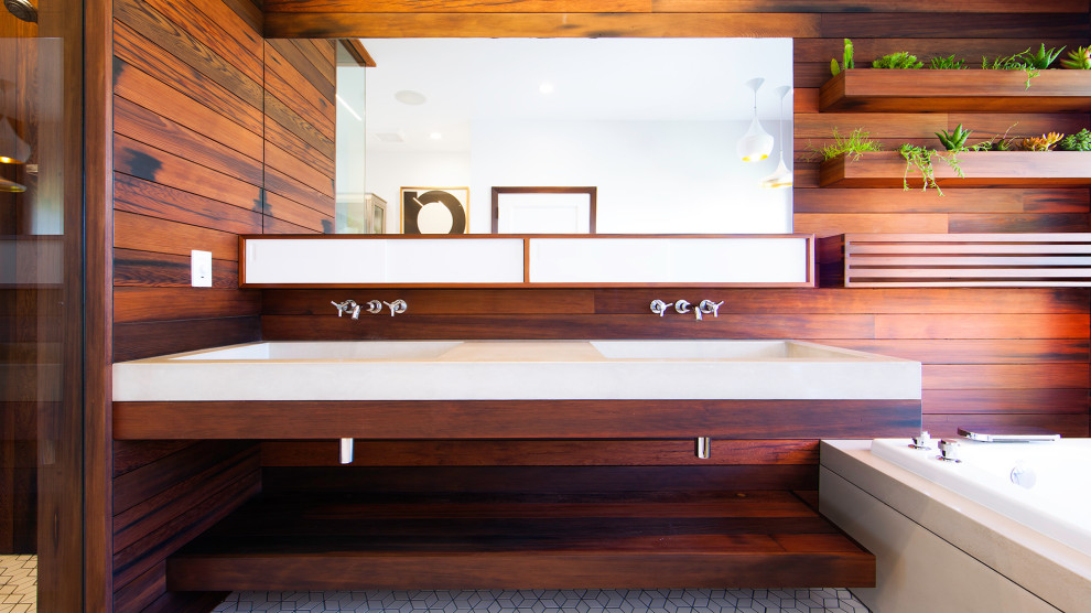 Inspiration for a modern master bathroom in San Francisco with medium wood cabinets, a wall-mount toilet, ceramic floors, a wall-mount sink, concrete benchtops, white floor, grey benchtops, a double vanity, a floating vanity and wood walls.