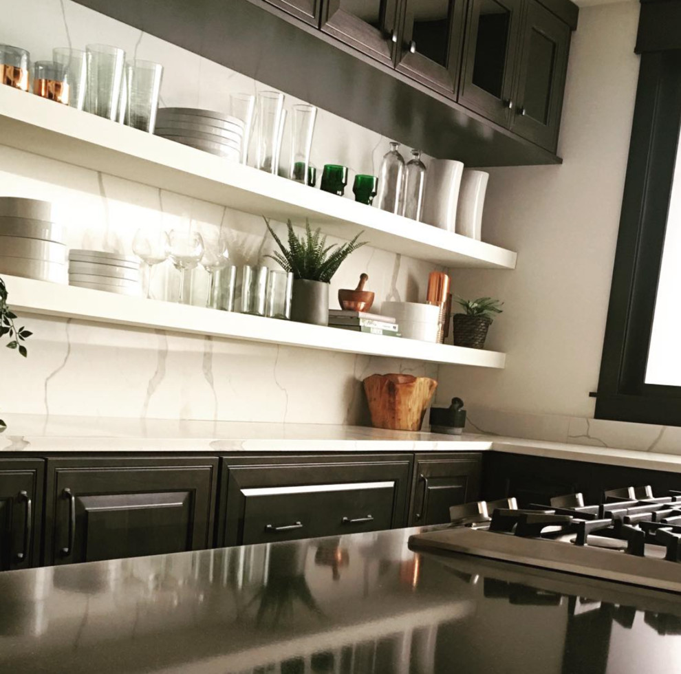 Large transitional l-shaped eat-in kitchen photo in Philadelphia with a farmhouse sink, raised-panel cabinets, medium tone wood cabinets, quartz countertops, white backsplash, stone slab backsplash, stainless steel appliances, two islands and white countertops