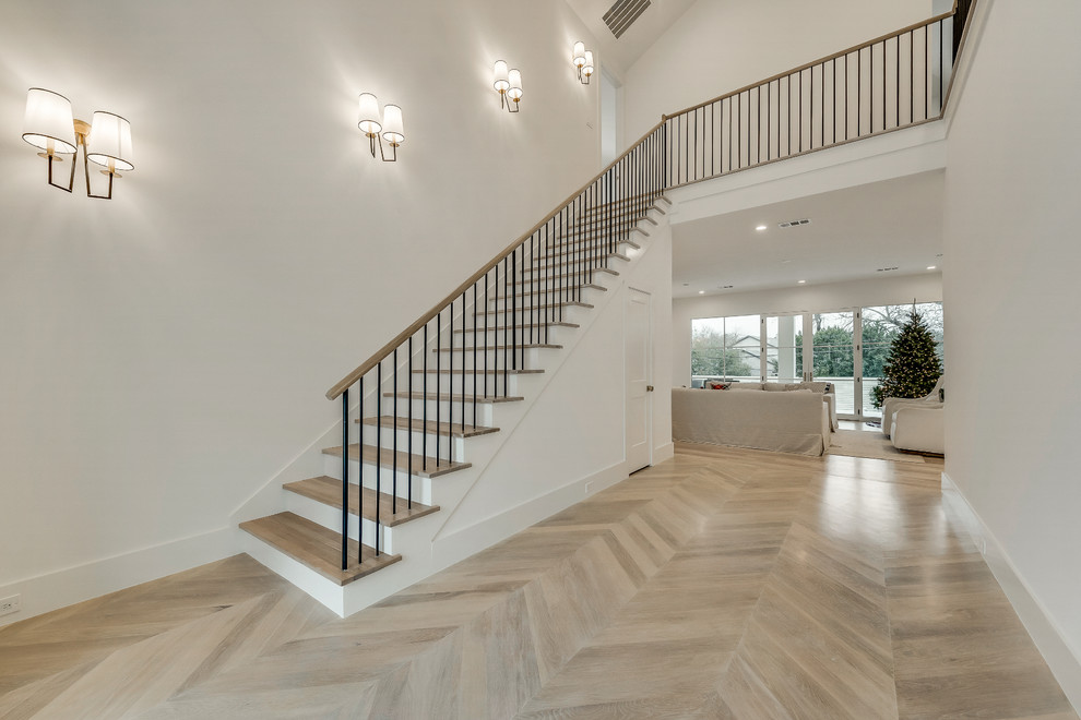 Inspiration for a contemporary foyer in Dallas with white walls, light hardwood floors, a double front door and a metal front door.