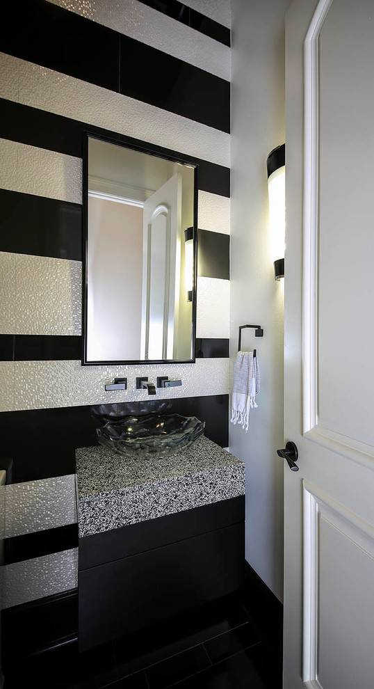 Design ideas for a small transitional powder room in New Orleans with a vessel sink, flat-panel cabinets, black cabinets, engineered quartz benchtops, multi-coloured tile, multi-coloured walls, porcelain floors and multi-coloured benchtops.
